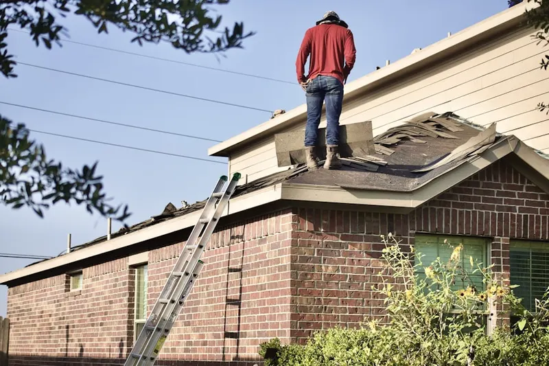 Professional roofer working on a residential roof in Columbia Heights